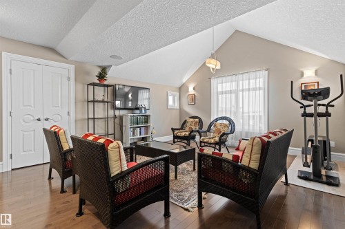 Featuring a textured ceiling, hardwood / wood-style floors, and vaulted ceiling - 2796 Wheaton Drive Nw, Edmonton, AB - Indoor