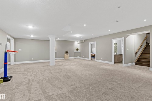 Finished below grade area featuring light colored carpet, stairway, and recessed lighting - 2796 Wheaton Drive Nw, Edmonton, AB - Indoor