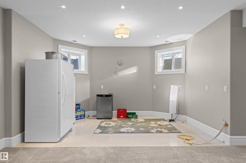 Kitchen with freestanding refrigerator, healthy amount of natural light, and light carpet - 2796 Wheaton Drive Nw, Edmonton, AB - Indoor Photo Showing Other Room
