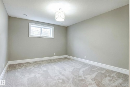 Empty room featuring baseboards and light carpet - 2796 Wheaton Drive Nw, Edmonton, AB - Indoor Photo Showing Other Room