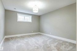 Empty room featuring baseboards and light carpet - 