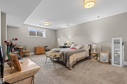 Bedroom featuring light colored carpet and baseboards - 