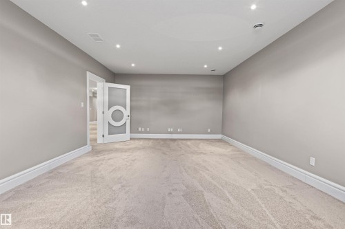 Home Theatre ready room with light carpet and recessed lighting - 2796 Wheaton Drive Nw, Edmonton, AB - Indoor Photo Showing Other Room