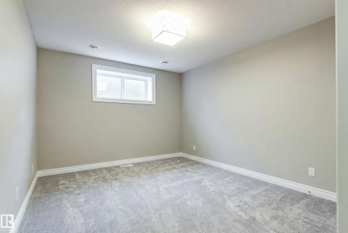 Unfurnished room with light carpet and a textured ceiling - 2796 Wheaton Drive Nw, Edmonton, AB - Indoor Photo Showing Other Room