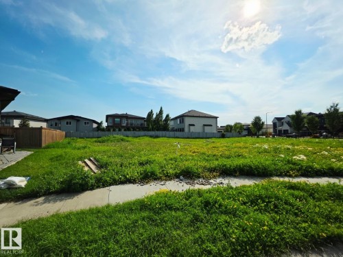 Expansive lot with established residential properties surrounding, featuring a concrete sidewalk at the perimeter - 4178 Cameron Heights Point(E) Nw, Edmonton, AB 