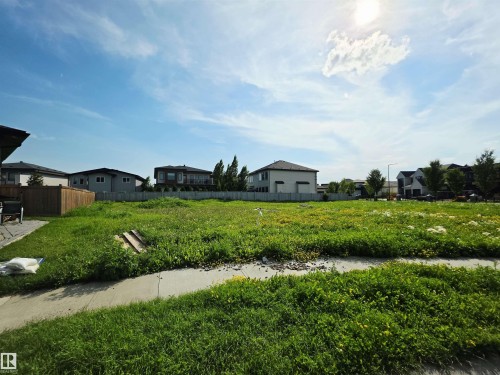 Expansive vacant lot featuring a sidewalk border and a clear, level building area - 4178 Cameron Heights Point(E) Nw, Edmonton, AB 