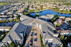 Multi-story residential complex featuring a central courtyard entrance and numerous private balconies - 