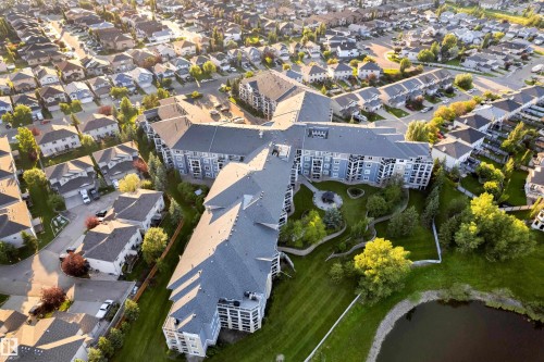 Multi-story residential building featuring a light blue facade and multiple balconies - #136 16035 132 St Nw, Edmonton, AB - Outdoor With View