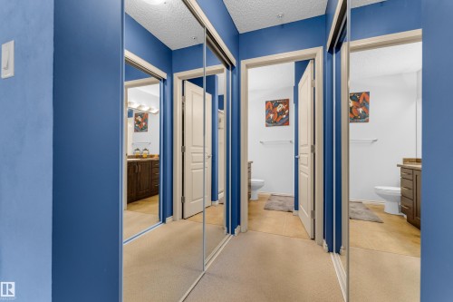 Mirrored closet doors offering a bright aesthetic - #136 16035 132 St Nw, Edmonton, AB - Indoor