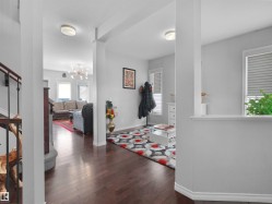 Hardwood-style flooring throughout, with light gray walls and white baseboards - 