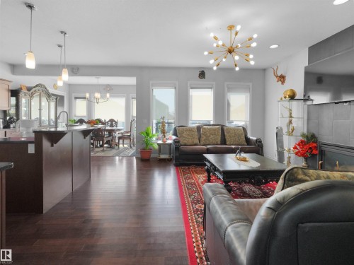 Open-concept living space with dark wood-finish flooring - 1716 60 Street Sw, Edmonton, AB - Indoor Photo Showing Living Room