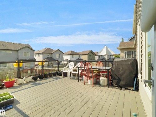 Expansive composite deck featuring a glass railing system and a siding exterior - 1716 60 Street Sw, Edmonton, AB - Outdoor With Deck Patio Veranda With Exterior