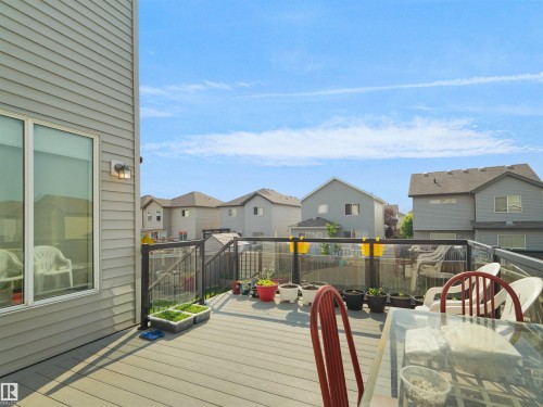 Expansive composite deck featuring a glass and metal railing system - 1716 60 Street Sw, Edmonton, AB - Outdoor With Deck Patio Veranda