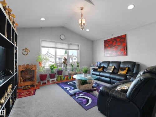 Vaulted ceilings featuring recessed lighting and a central chandelier - 1716 60 Street Sw, Edmonton, AB - Indoor Photo Showing Living Room