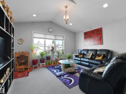 Vaulted ceilings featuring recessed lighting and a central chandelier - 