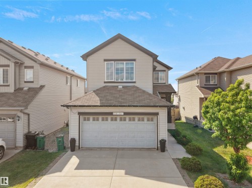 Two-story residential structure with light-colored siding, a dark roof, and a two-car garage - 1716 60 Street Sw, Edmonton, AB - Outdoor With Facade