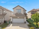 Two-story residential structure with light-colored siding, a dark roof, and a two-car garage - 1716 60 Street Sw, Edmonton, AB  - Outdoor With Facade 