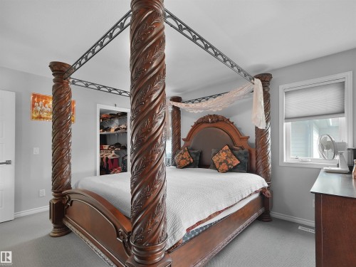 Carpeted room featuring a window with cellular shades, light gray wall paint, and white trim - 1716 60 Street Sw, Edmonton, AB - Indoor Photo Showing Bedroom