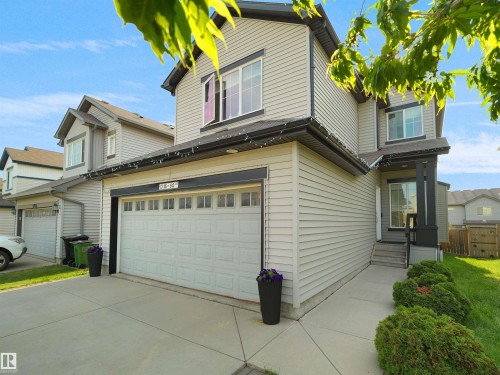 Two-story residence featuring light-toned siding and dark trim accents - 1716 60 Street Sw, Edmonton, AB - Outdoor
