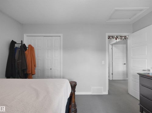 Bedroom featuring light gray walls and gray carpeting - 1716 60 Street Sw, Edmonton, AB - Indoor Photo Showing Bedroom