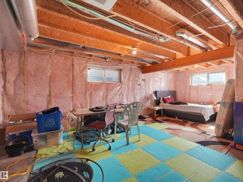 Unfinished basement with exposed wood framing and insulation-ready walls - 1716 60 Street Sw, Edmonton, AB - Indoor Photo Showing Basement