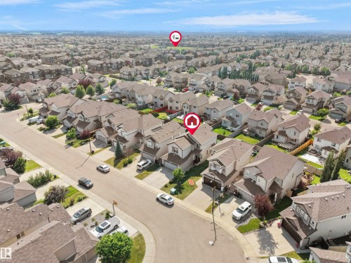 Spacious suburban neighborhood featuring varied rooflines, paved streets, and ample green spaces - 1716 60 Street Sw, Edmonton, AB - Outdoor With View