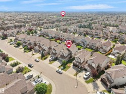 Spacious suburban neighborhood featuring varied rooflines, paved streets, and ample green spaces - 