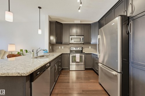 #110 6083 Maynard Wy Nw, Edmonton, AB - Indoor Photo Showing Kitchen With Double Sink