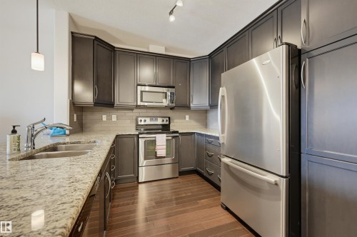 #110 6083 Maynard Wy Nw, Edmonton, AB - Indoor Photo Showing Kitchen With Double Sink With Upgraded Kitchen