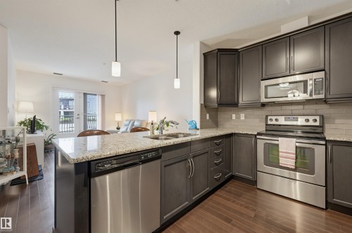 #110 6083 Maynard Wy Nw, Edmonton, AB - Indoor Photo Showing Kitchen With Double Sink With Upgraded Kitchen
