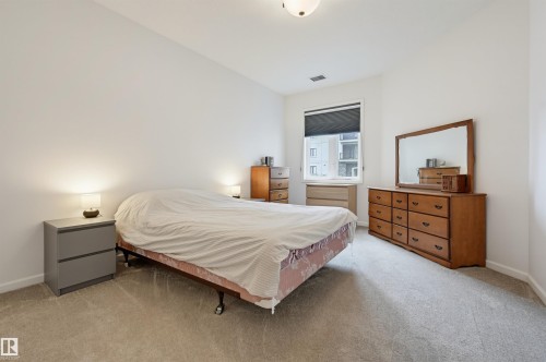 #110 6083 Maynard Wy Nw, Edmonton, AB - Indoor Photo Showing Bedroom