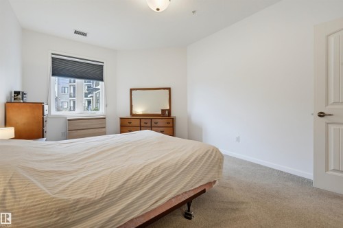 #110 6083 Maynard Wy Nw, Edmonton, AB - Indoor Photo Showing Bedroom