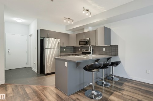 #103 10611 117 St Nw, Edmonton, AB - Indoor Photo Showing Kitchen With Stainless Steel Kitchen