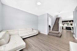 Open concept living area with wood-finish flooring - 