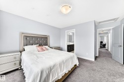 Bedroom featuring light gray wall paint and gray carpeting - 