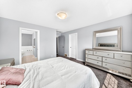 Bedroom featuring light gray walls and dark carpeting - 17508 58 Street Nw, Edmonton, AB - Indoor Photo Showing Bedroom