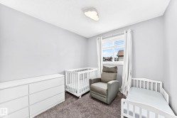 Soft gray wall paint with textured ceiling, featuring a window with white blinds and curtains, and plush gray carpeting - 