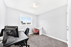 Bright room featuring a window with white trim, light gray walls, and textured carpet flooring - 