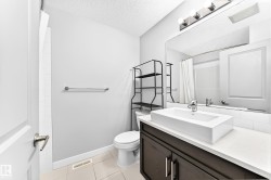 Modern bathroom vanity with a white rectangular vessel sink, contemporary chrome faucet, and spacious countertop - 