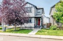 Two-story residence featuring light gray siding with dark trim accents and a vibrant red entry door - 17508 58 Street Nw, Edmonton, AB  - Outdoor With Facade 