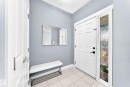 Entryway featuring a paneled door with matte black hardware, an etched glass sidelight, and light tile flooring - 17508 58 Street Nw, Edmonton, AB  - Indoor Photo Showing Other Room 
