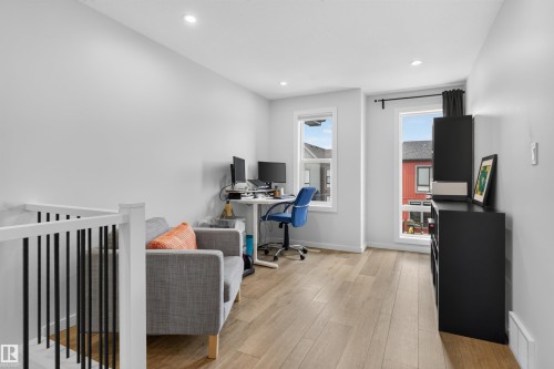 Open concept landing area featuring light wood-finish flooring, recessed lighting, and white walls - #84 1304 Rutherford Rd Sw, Edmonton, AB - Indoor