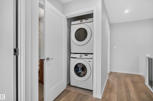 Dedicated laundry closet featuring a stacked washer and dryer - #84 1304 Rutherford Rd Sw, Edmonton, AB - Indoor Photo Showing Laundry Room