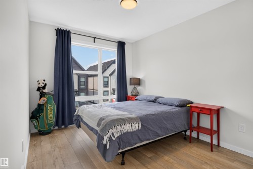Bright room featuring wood-finish flooring and light-toned walls - #84 1304 Rutherford Rd Sw, Edmonton, AB - Indoor Photo Showing Bedroom