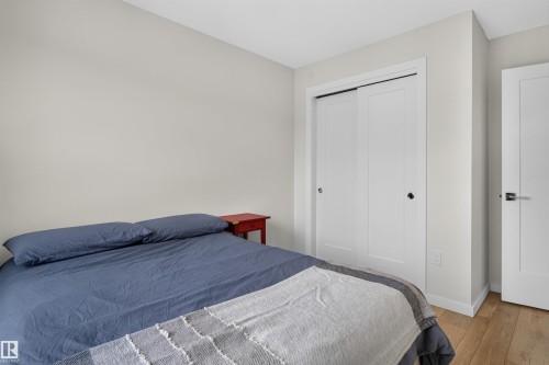 Room featuring wood-finish flooring, light-toned walls, and white trim - #84 1304 Rutherford Rd Sw, Edmonton, AB - Indoor Photo Showing Bedroom