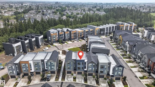 Modern townhome with a multi-level facade, integrated garage, and contemporary exterior finishes - #84 1304 Rutherford Rd Sw, Edmonton, AB - Outdoor
