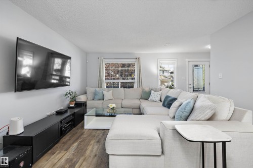 Living area featuring wood-finish flooring and light gray wall paint - 12305 173A Avenue Nw, Edmonton, AB - Indoor Photo Showing Living Room