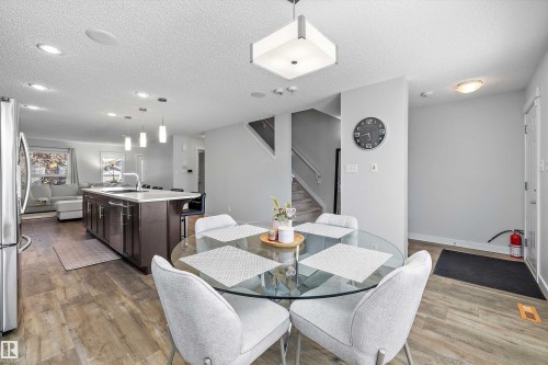 Open-concept main living area with wood-finish flooring - 12305 173A Avenue Nw, Edmonton, AB - Indoor Photo Showing Dining Room