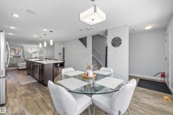 Open-concept main living area with wood-finish flooring - 