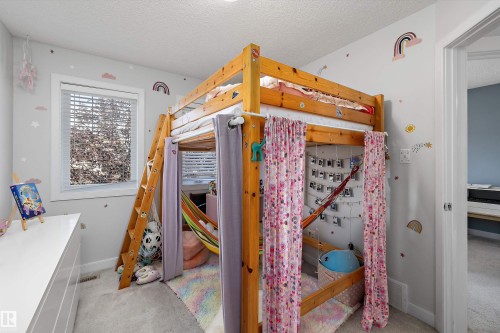 Bedroom featuring a light wood-finish loft bed, a single window with blinds, and light gray wall-to-wall carpeting - 12305 173A Avenue Nw, Edmonton, AB - Indoor Photo Showing Other Room